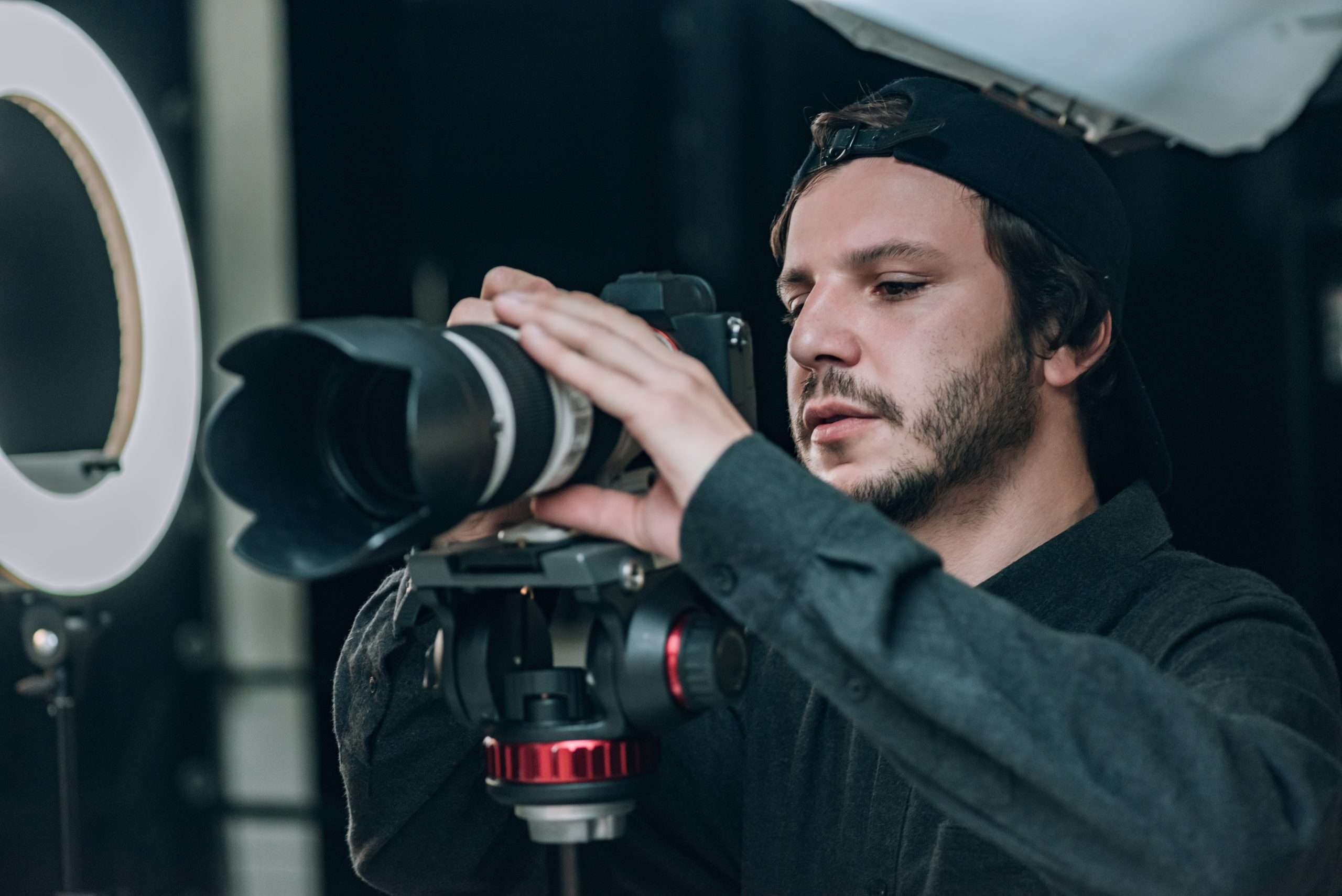 A man holding a camera in front of a light.