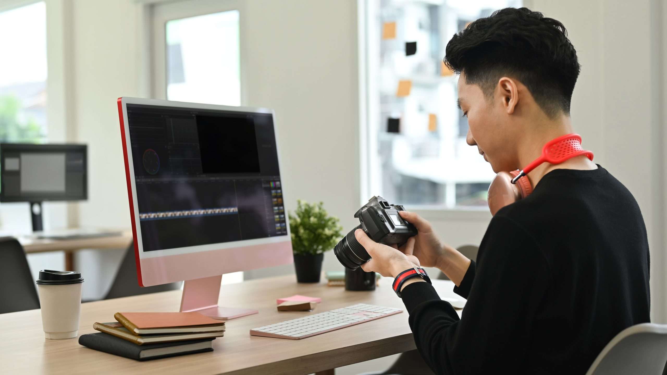A man sitting at a desk with a camera in front of him.