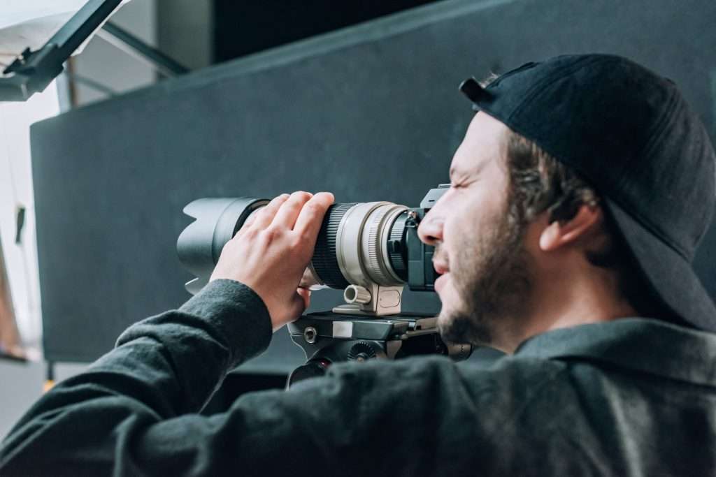 A man is taking a picture with a camera.