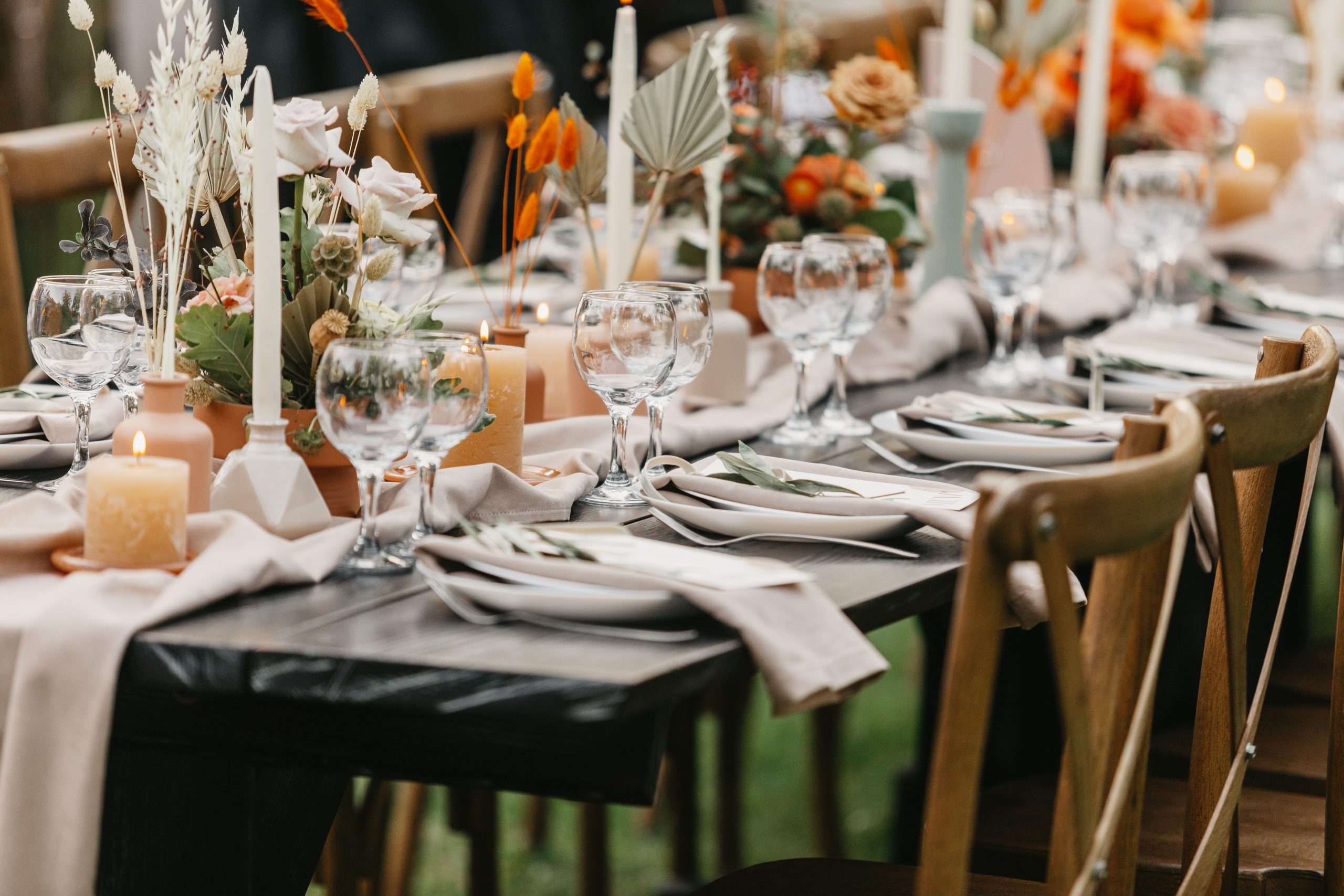 A table set up for a wedding with candles and flowers.