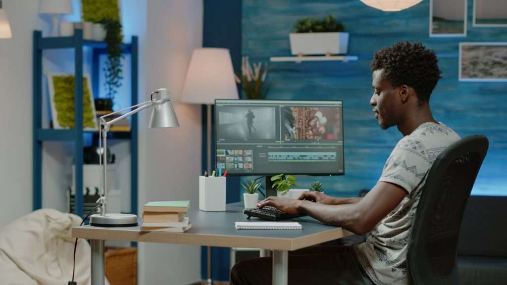 A man working on a computer in his home office.