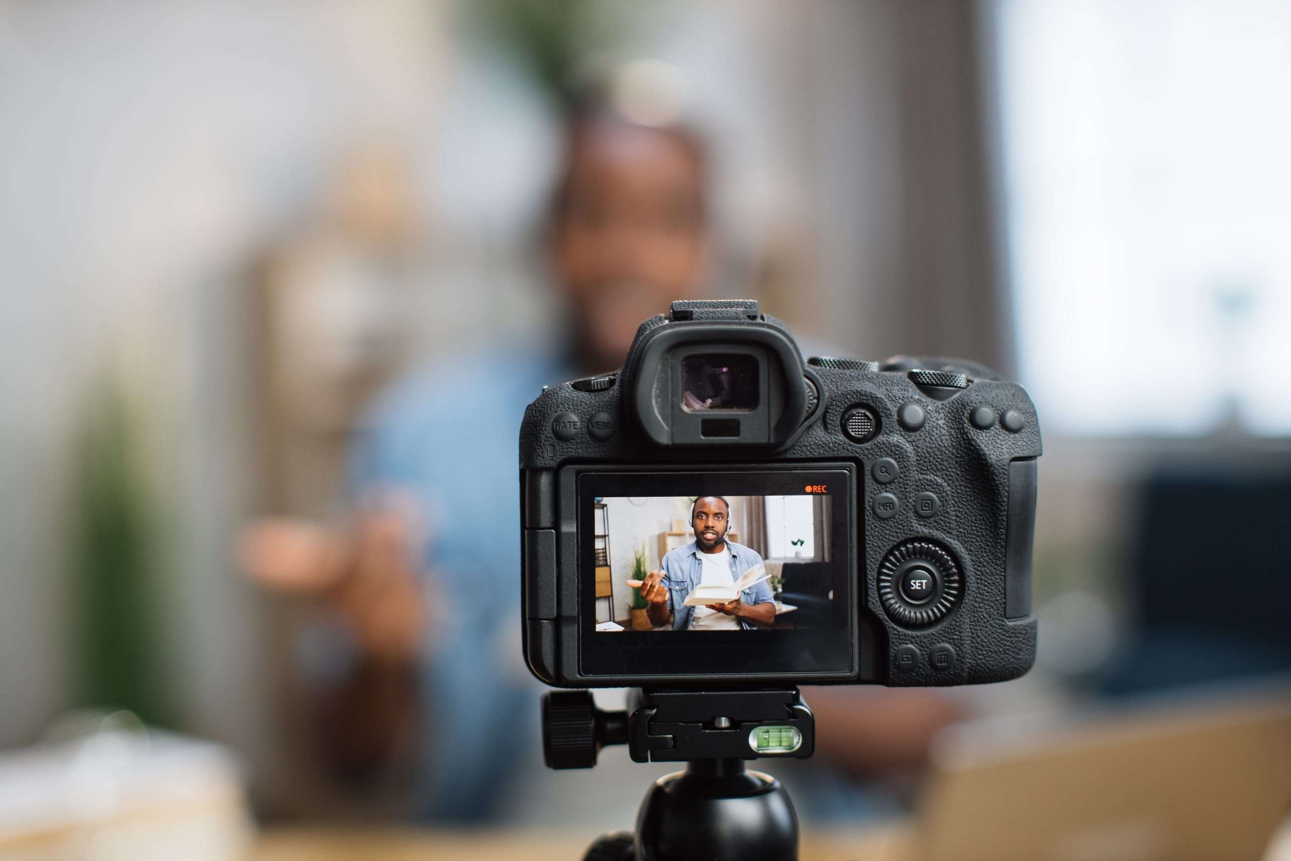 A man is capturing a video using a camera.